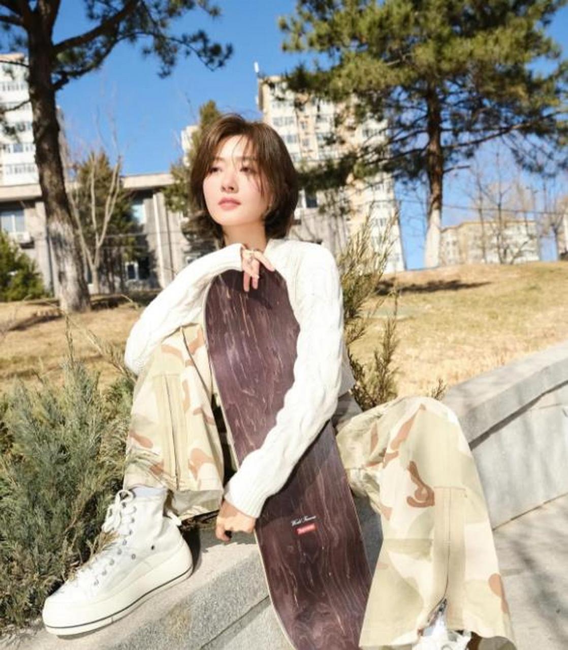 万茜穿着白色针织毛衣,搭配浅色迷彩长裤,性感迷人!