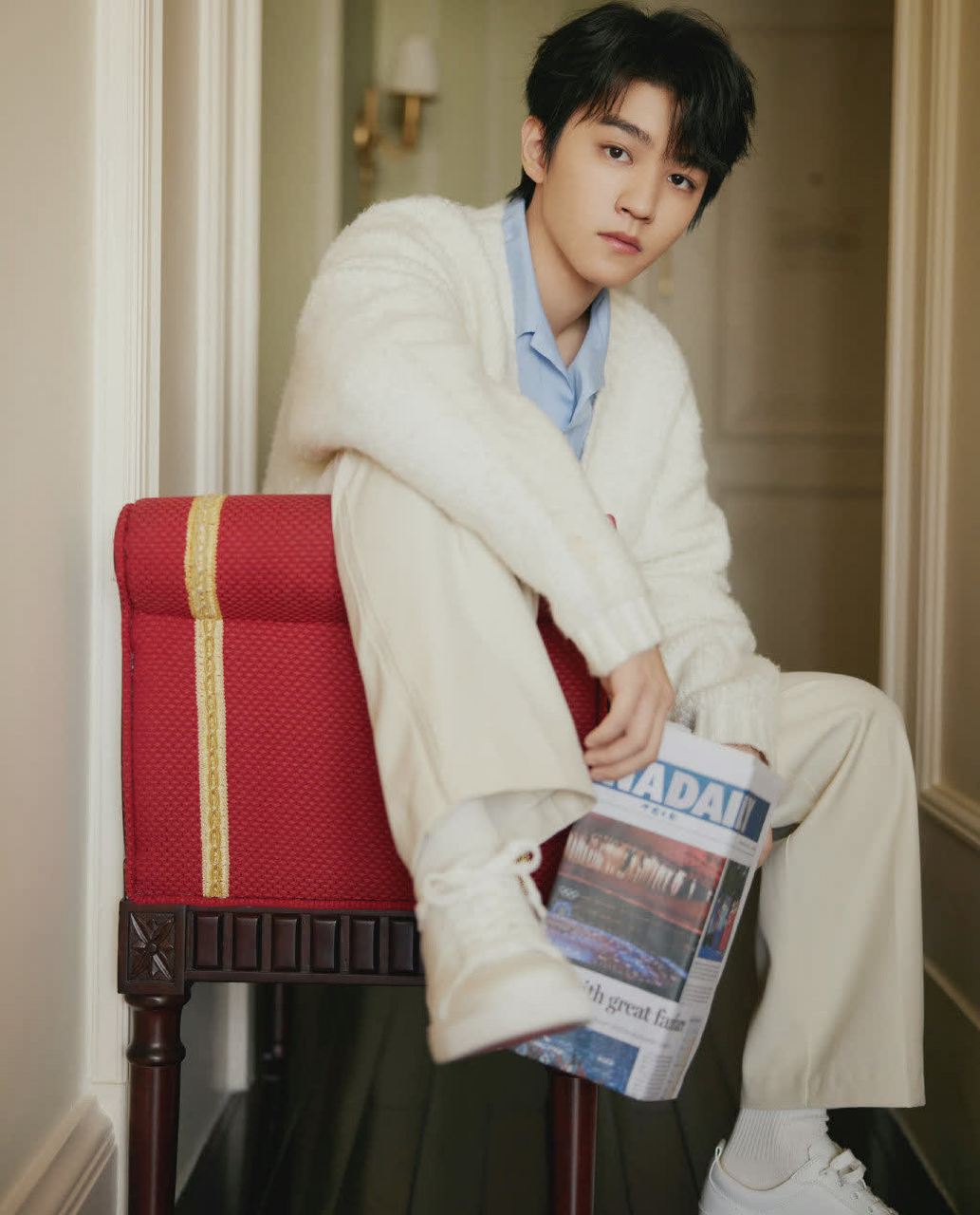 王俊凯身穿开衫毛衣,蓝色衬衫,白色袜子和白色鞋子.