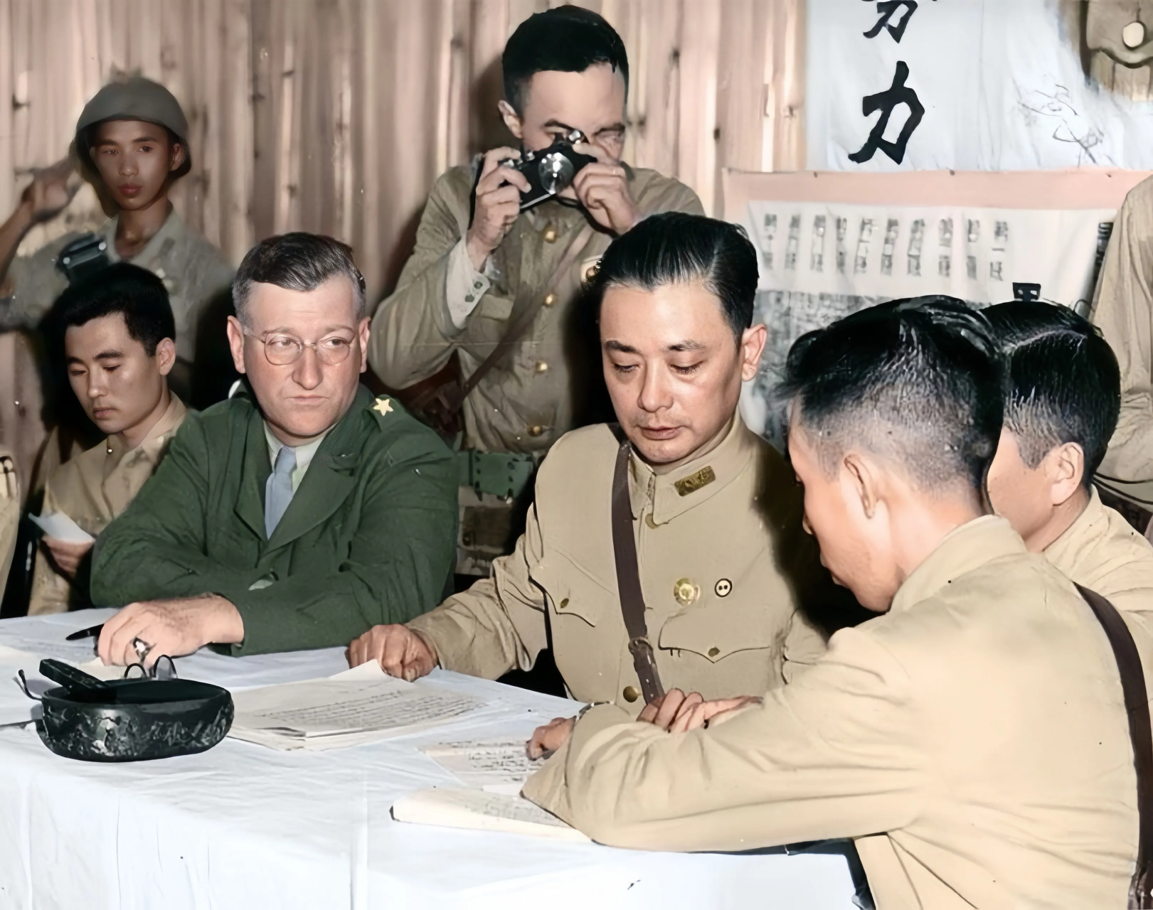 945年8月21日,中国战区陆军总司令部参谋长萧毅肃(中)在芷江参加洽降