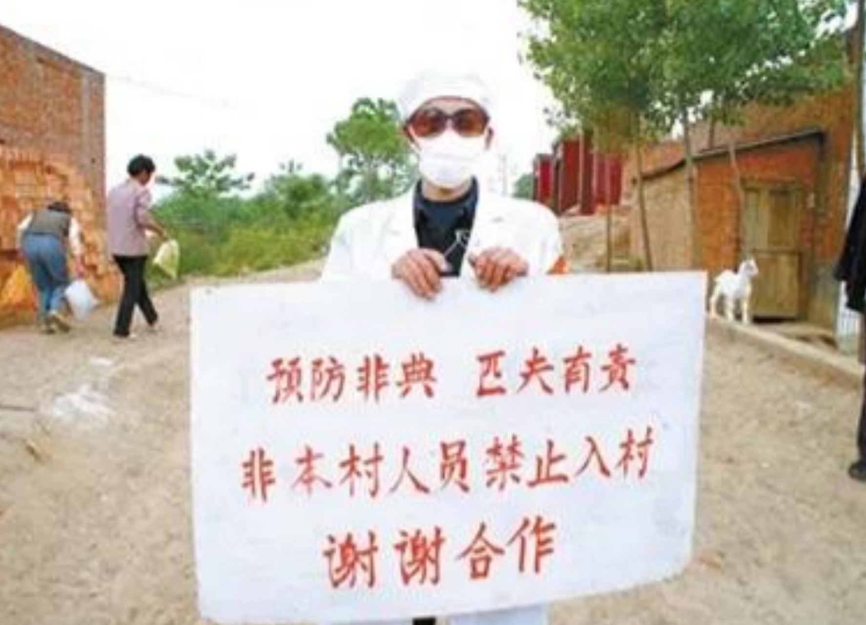 2003年非典,村口的守村人全副武装严格管控进出村人员.