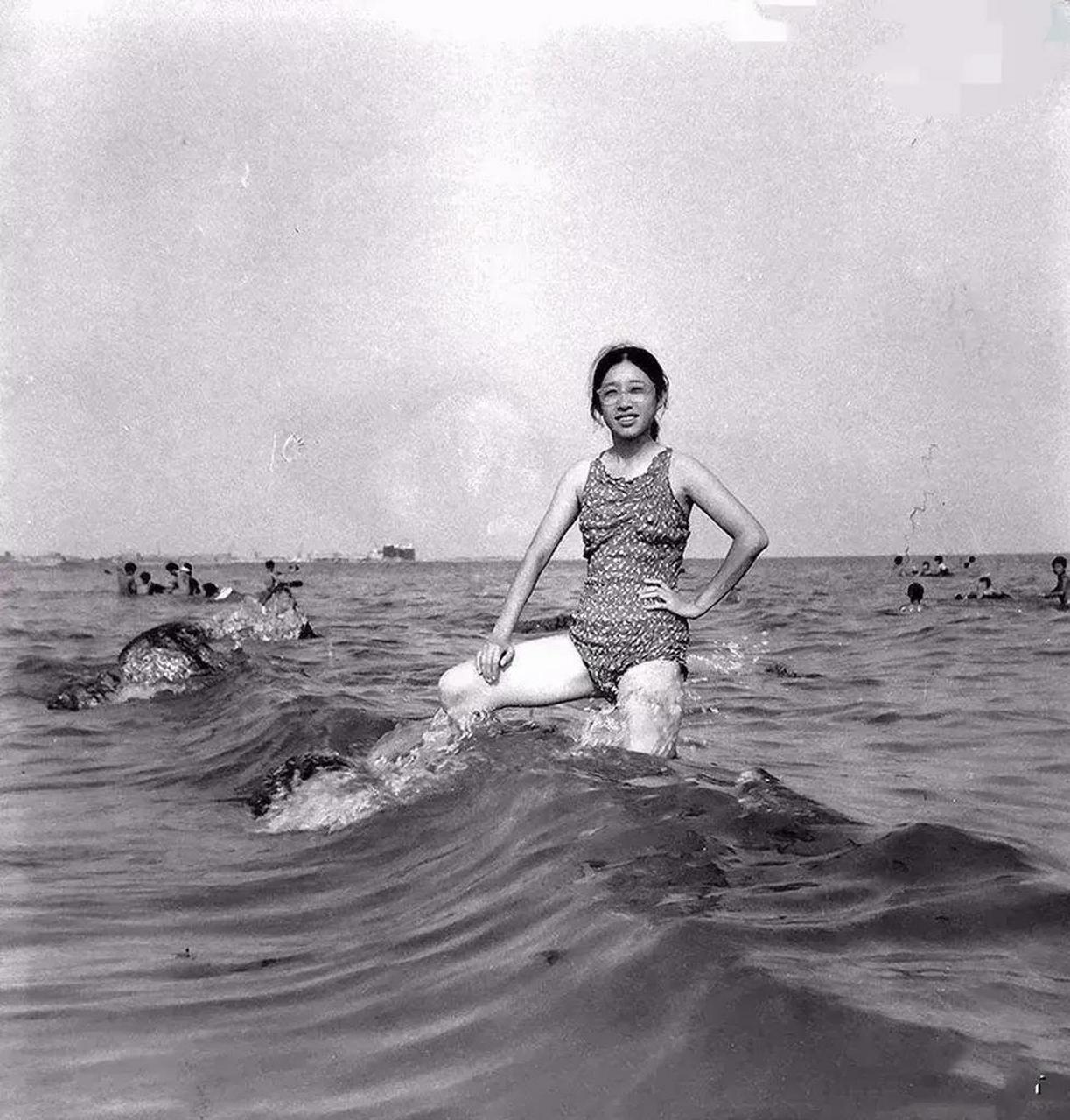 她身穿一身泳衣,佩戴着一副眼镜,看起来很文静.