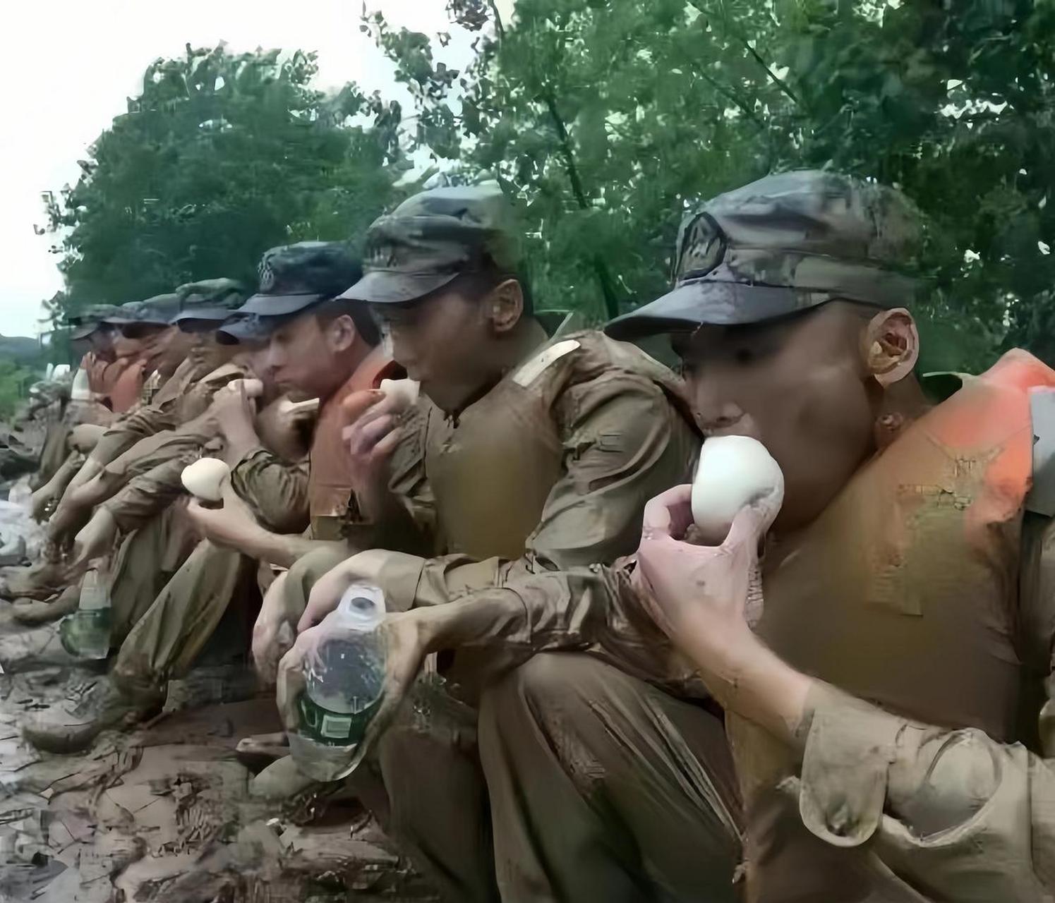 这是抗洪战士们在吃饭的情景,他们刚刚参加完抗洪救灾,满身都是泥巴