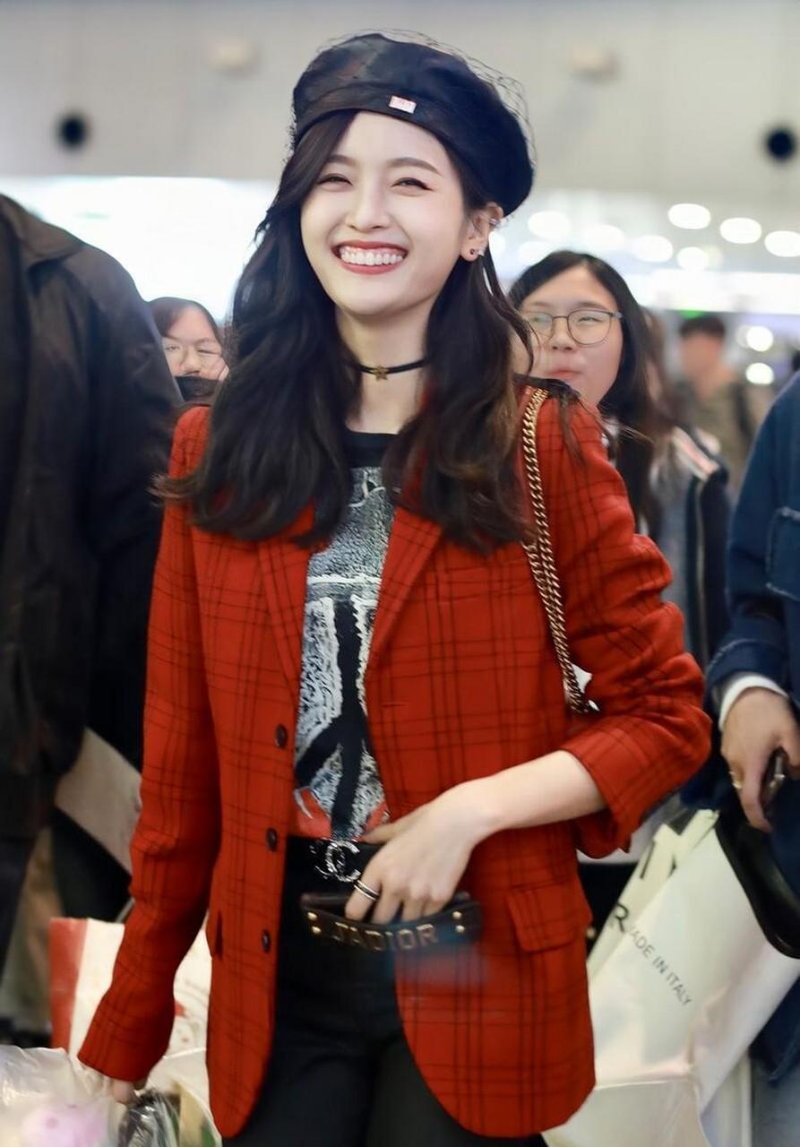 吴宣仪机场街拍,贝雷帽搭红色西装 牛仔裤收获粉丝礼物开心大笑