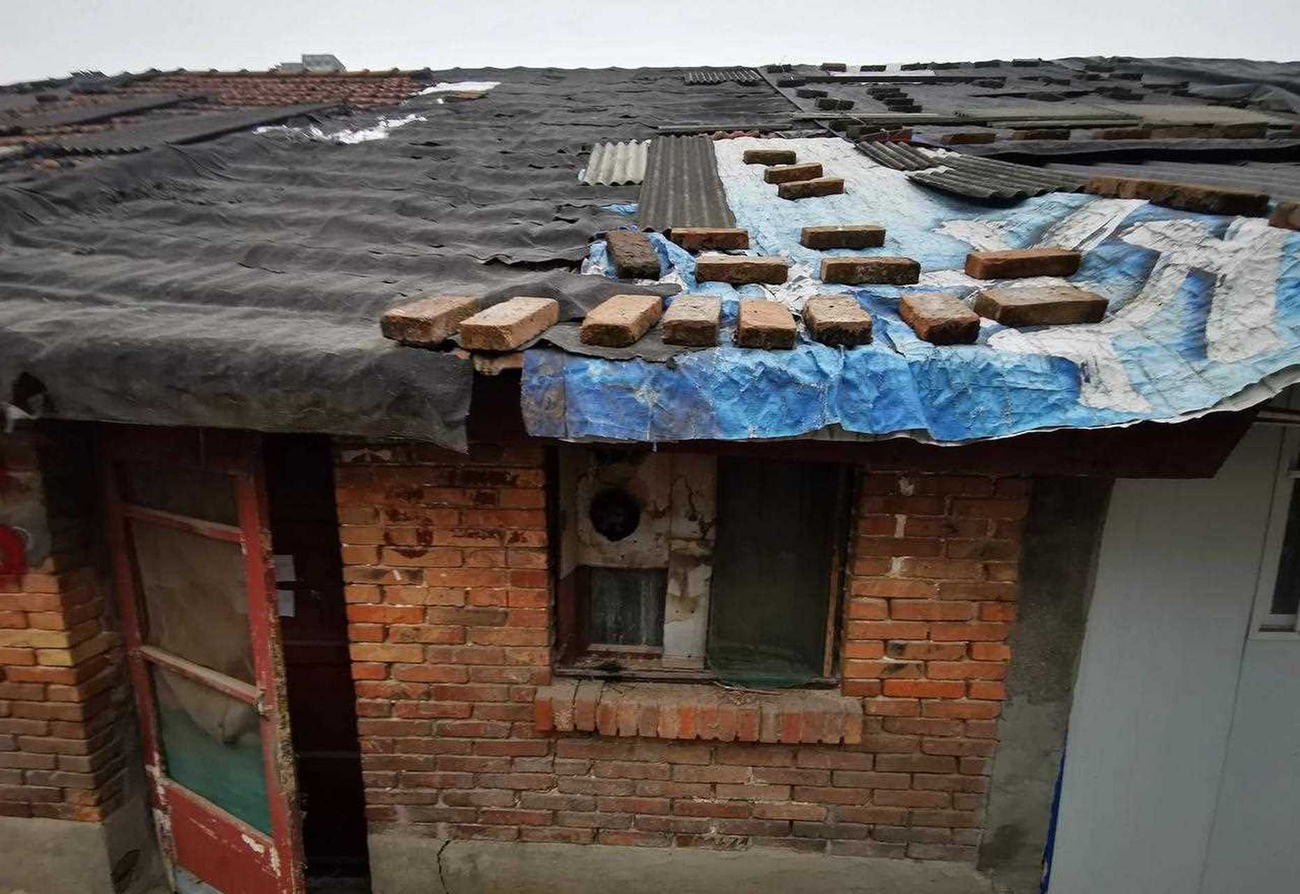 身在闹市区的竟有一处低矮平房,最矮的一排房子,户门高度只有一米八