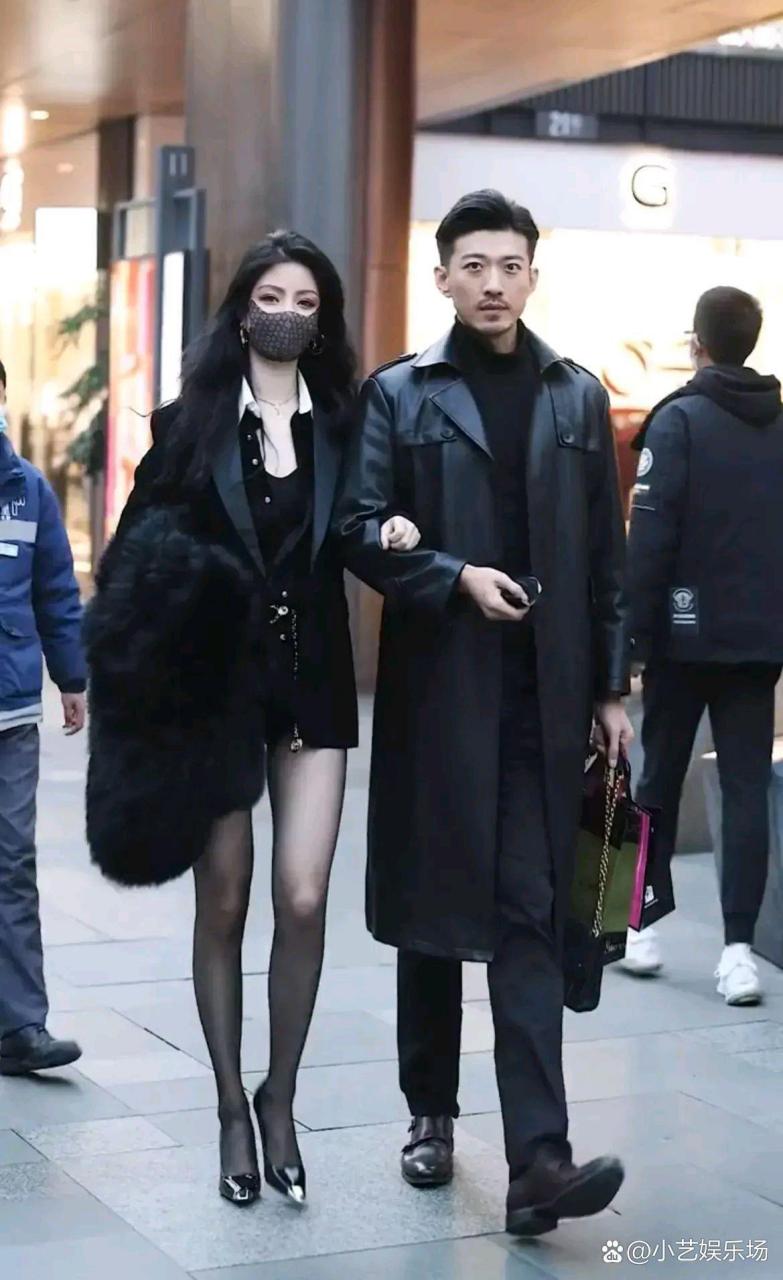 一对情侣手挽手出现在街上,吸引了许多路人的目光.