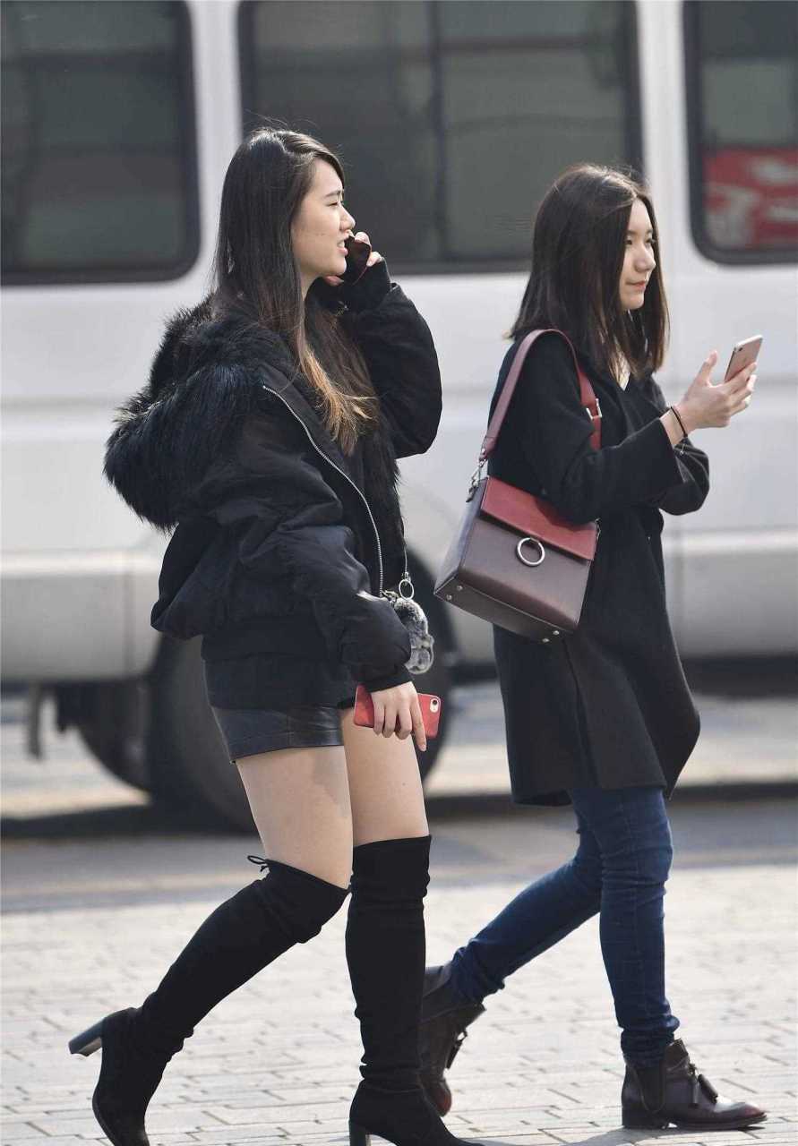 黑色粗跟过膝靴,搭配黑色皮短裤,一款黑色羽绒服,美女春季出门,注意