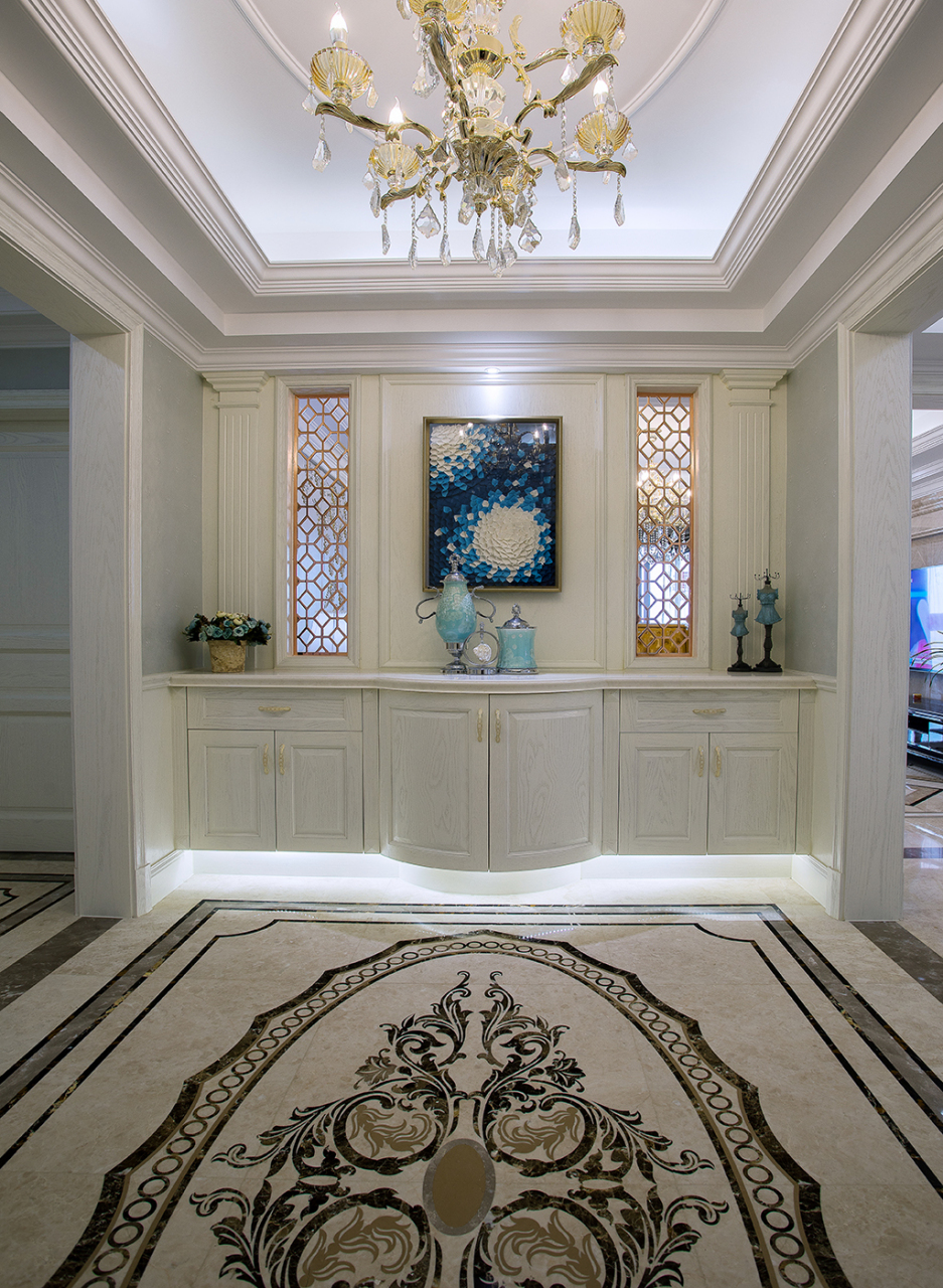 玄关处的格挡采用了部分镂空的造型,搭配精美的油画,艺术摆件及花纹