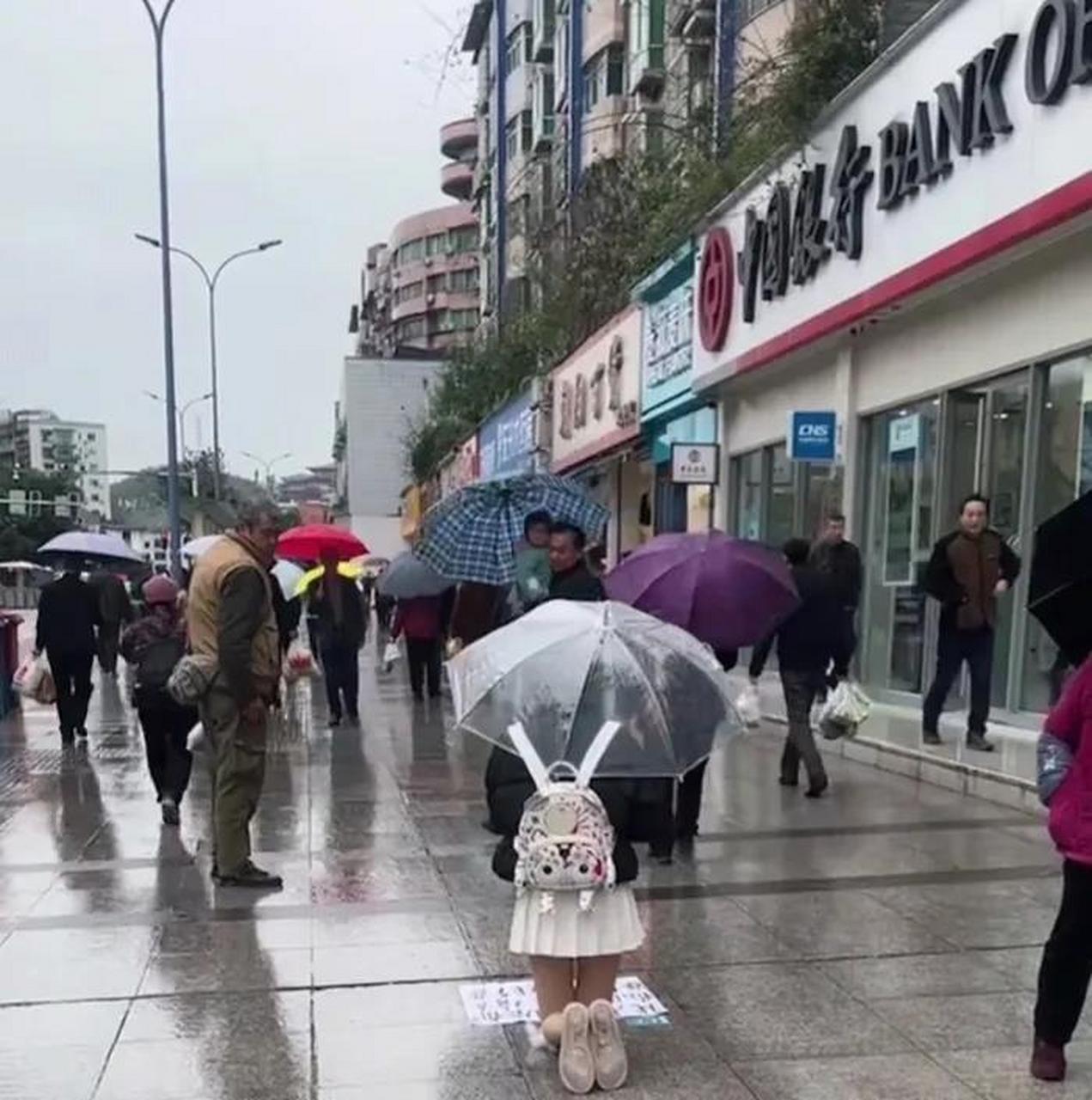 陰涼的下雨天,雙腿白皙的女孩跪在路邊,路人看見或許