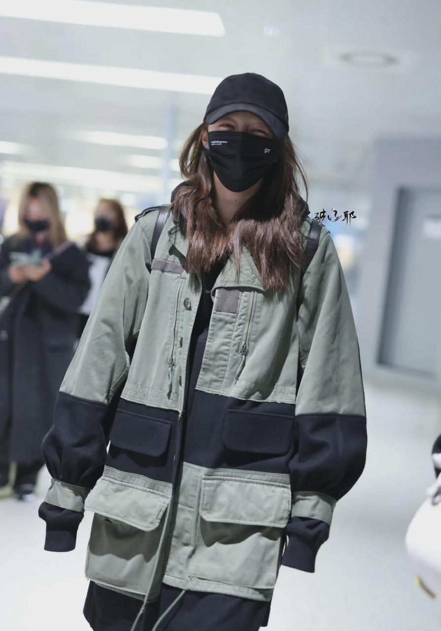 关晓彤今日机场私服街拍 中长款大口袋工装外套内搭印花连帽卫衣,九分