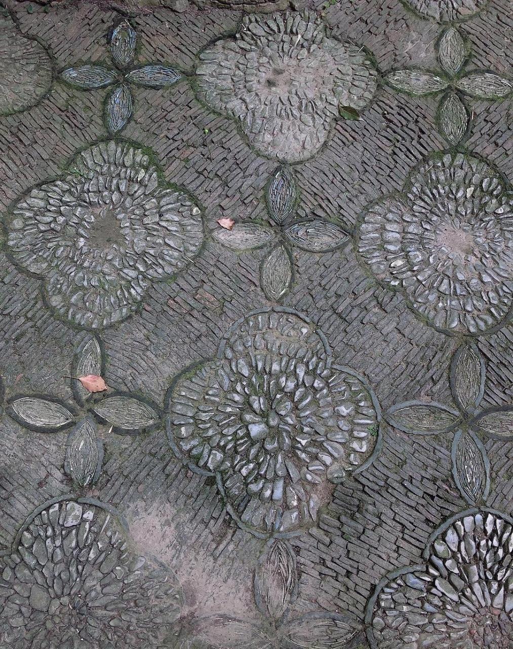 花街铺地是园林中一种地面铺装工艺,是以瓦片,各色卵石,碎石,碎瓷片等