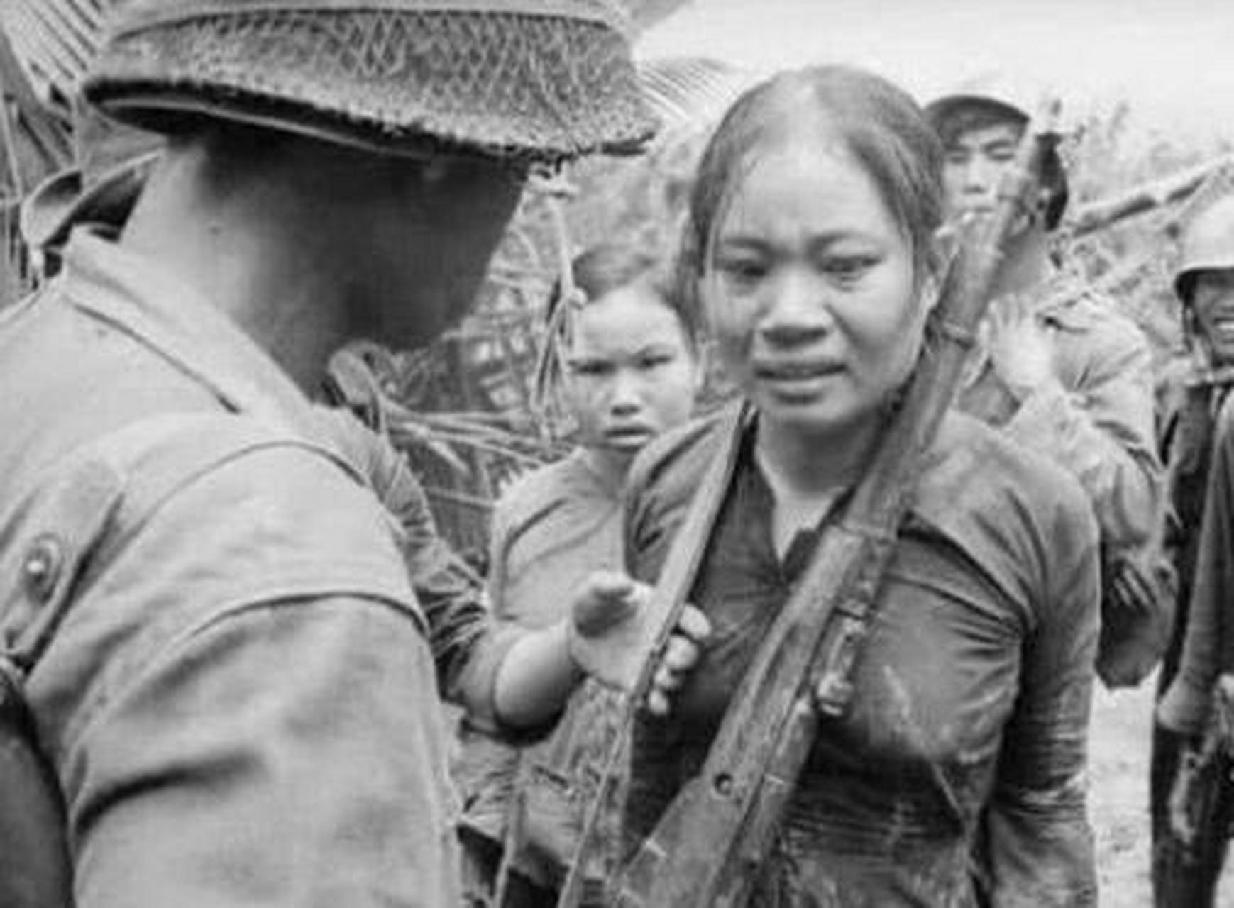1971年越战时期,一位年轻的越南女兵被美国大兵扛在肩上.