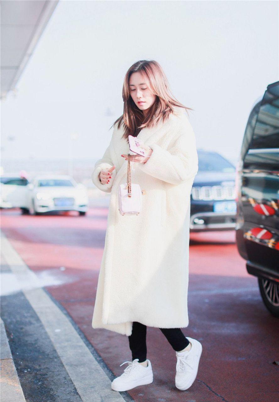 刘芸素颜现身机场,白色毛绒长款大衣搭配小白鞋,休闲又时尚,整体看