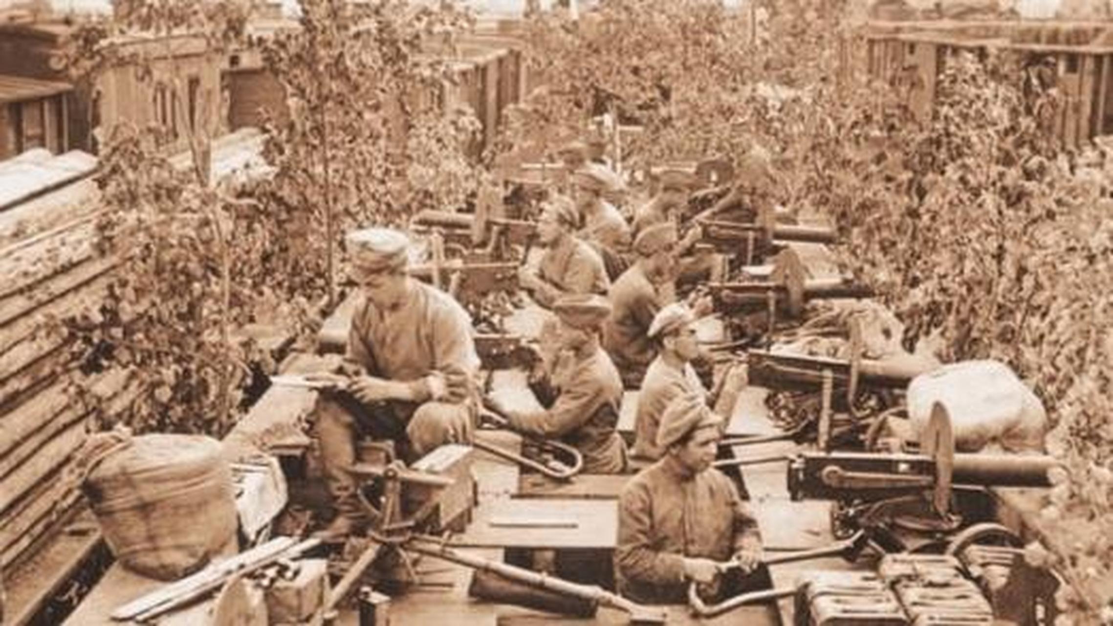 1919年苏俄内战中,一列用树枝伪装后的白卫军装甲列车驶入车站,仅图中