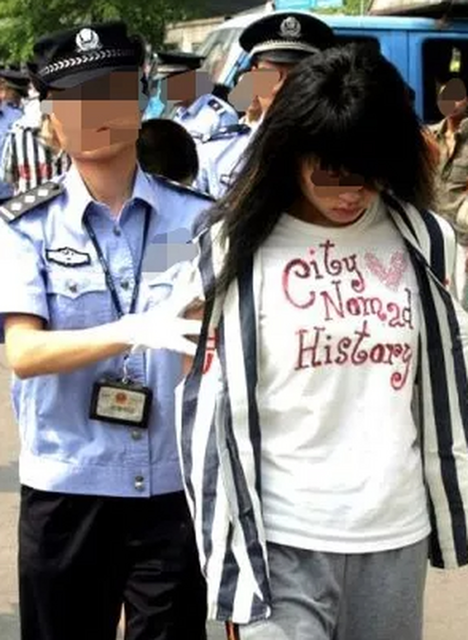 照片为美女犯罪嫌疑人韦某被押解的情形.