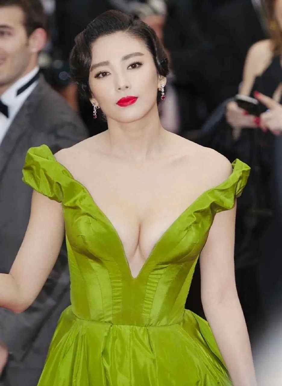 张雨绮涂大红色唇膏,手拿红色亮片包,穿绿色礼服裙走红毯十分抢眼.