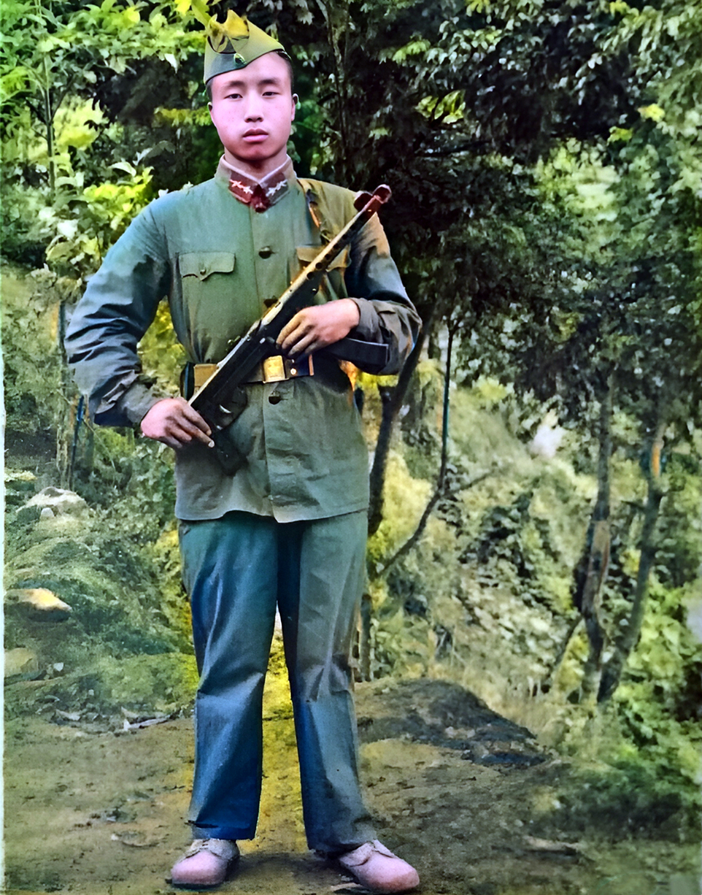 1950年代,一名解放军战士双手持枪拍照