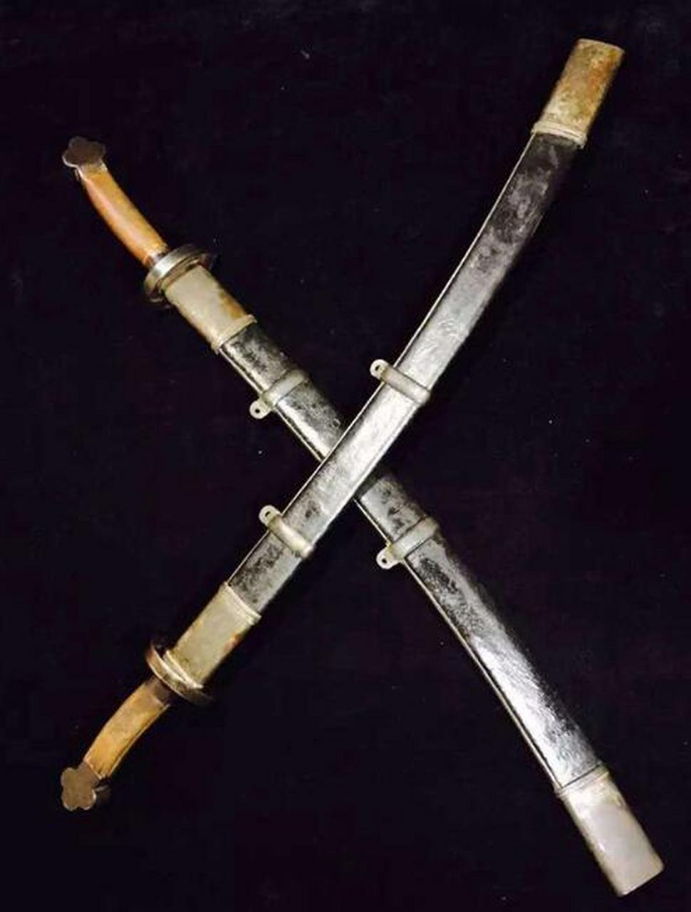 民国时期,一名民兵手持着一把令人瞩目的马刀,这把刀具具备马家军特有