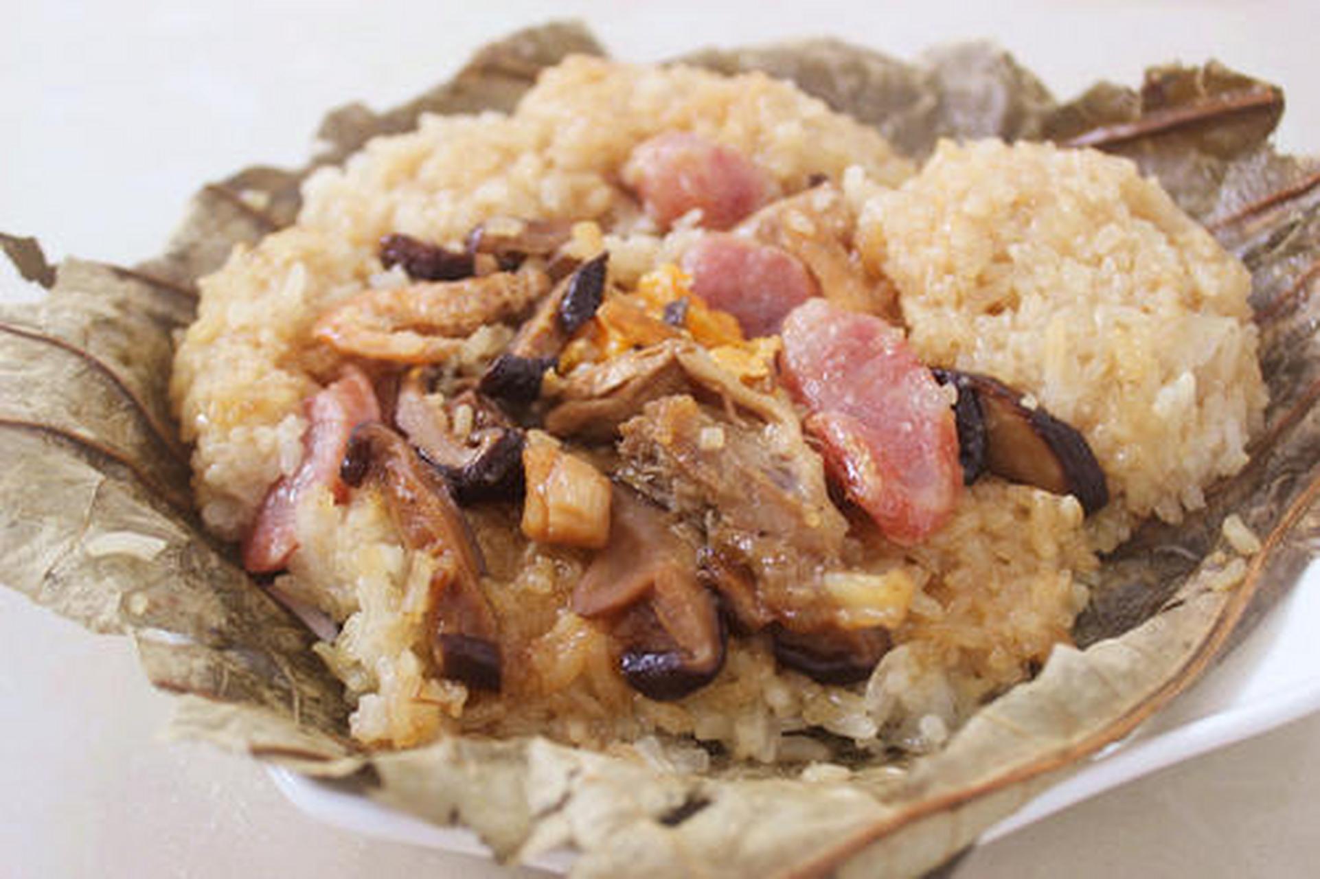 糯米鸡是广东的特色早餐,用荷叶包着糯米饭和鸡块,将荷叶的香味透进饭