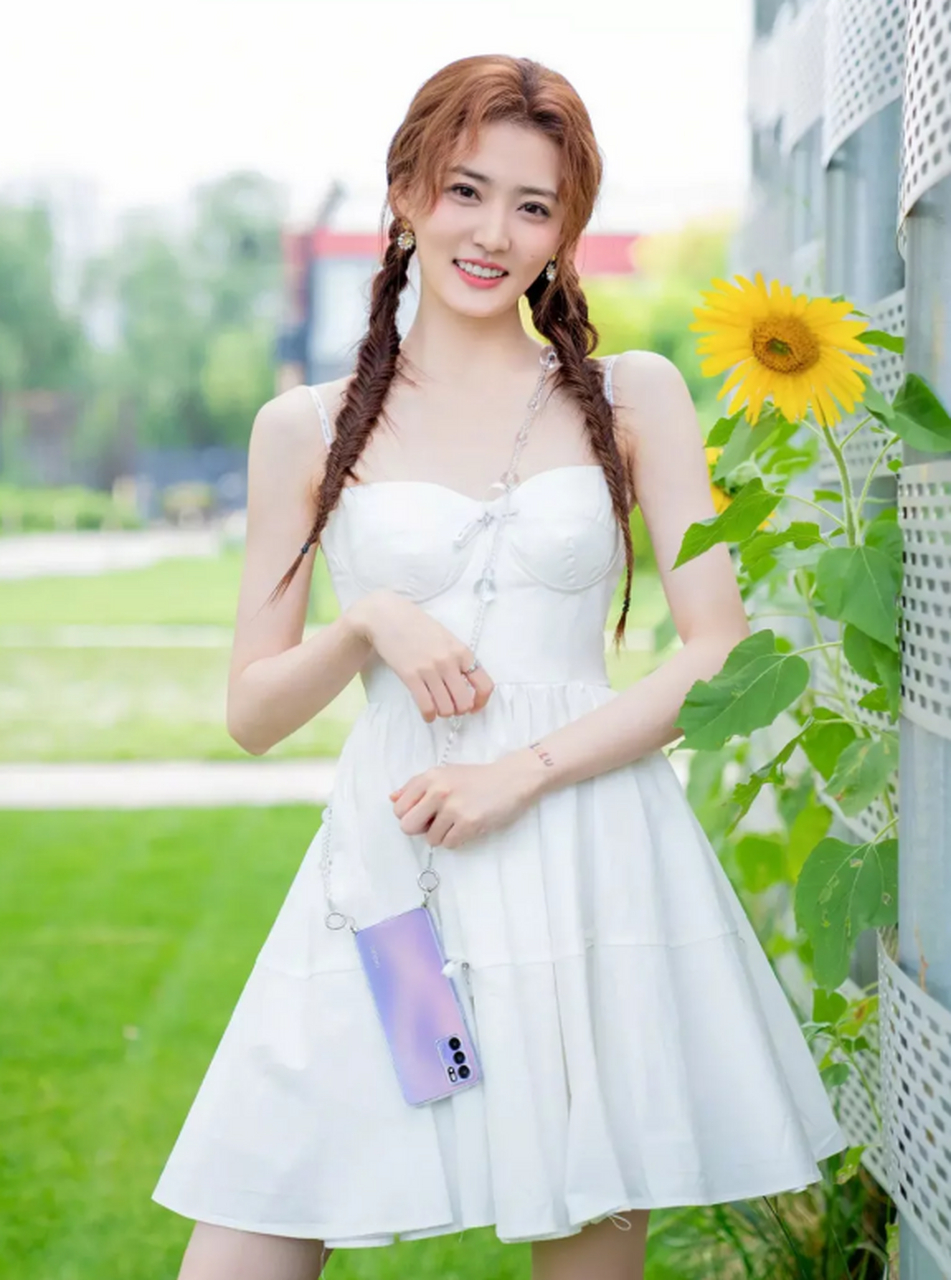 徐璐身穿白色吊带连衣裙,,梳了两个小辫子甜美可爱