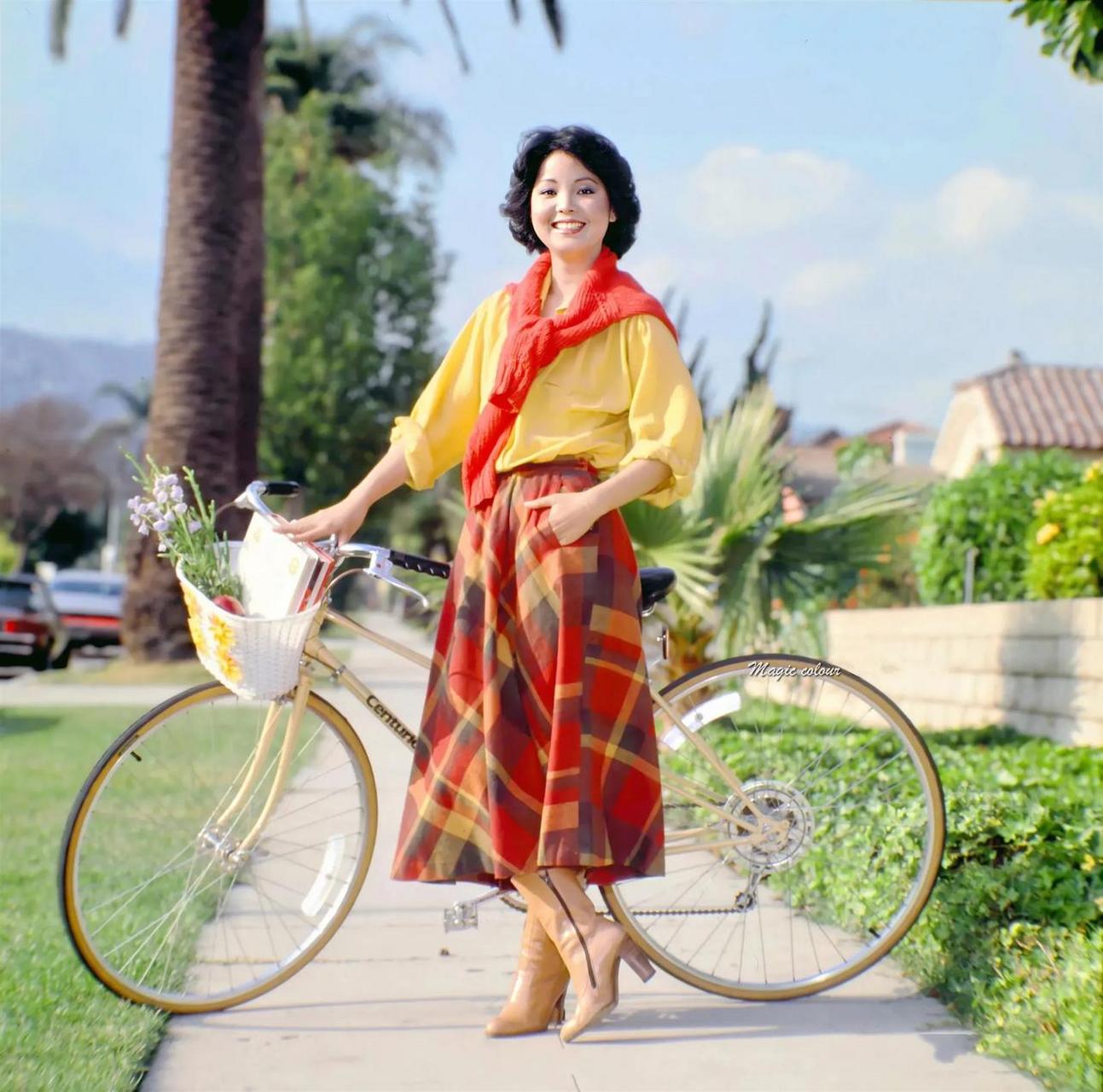 1980年的台北,邓丽君穿着一身亮色服装,推着一辆自行车,在市区穿梭.