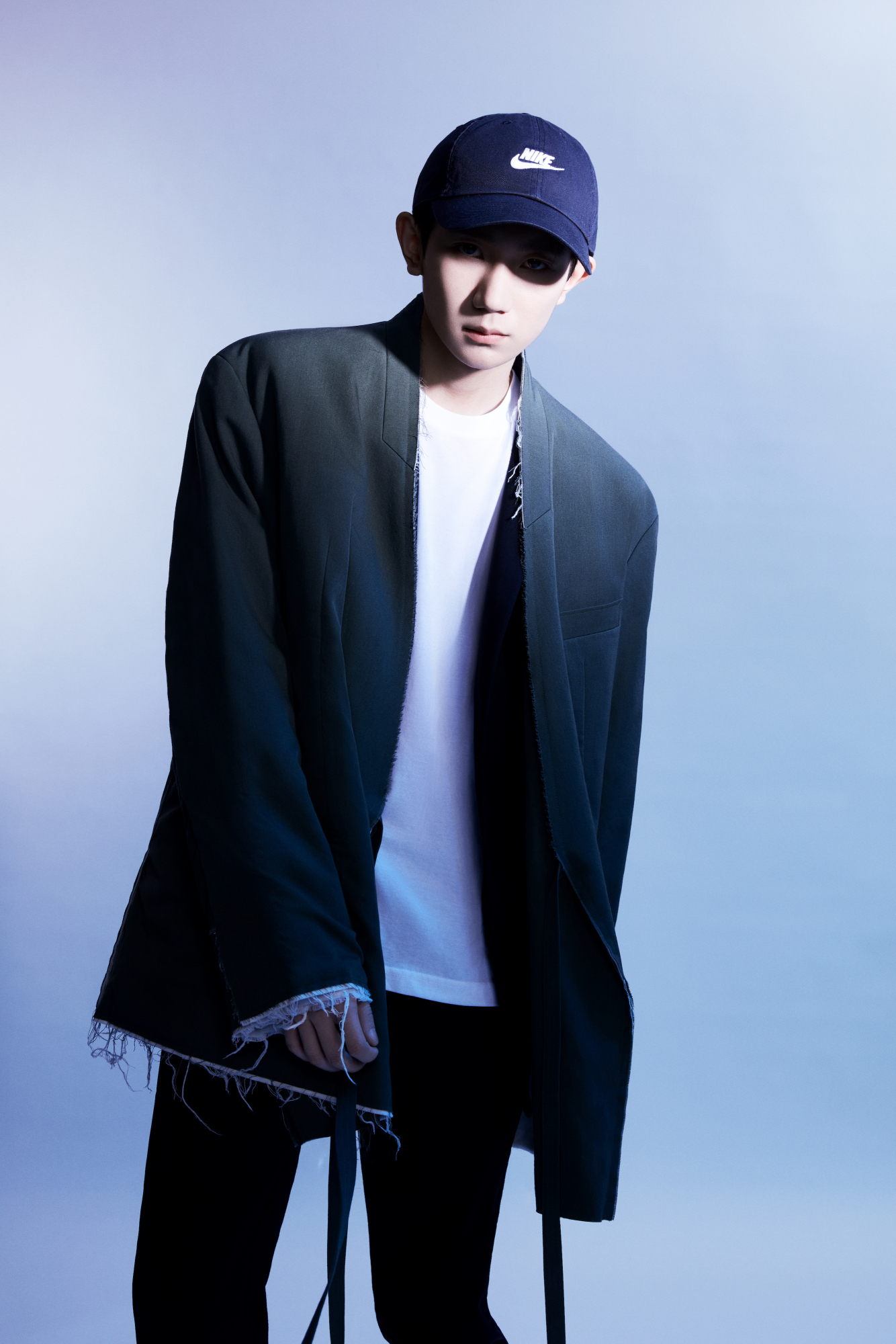 王源黑色棒球帽搭配白t恤叠穿黑西装,光影下是少年硬朗的轮廓