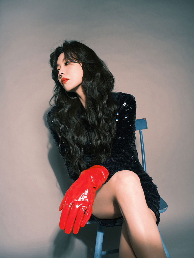 王霏霏出席芒果年货节 复古波浪卷发搭配亮面红手套摩登感十足