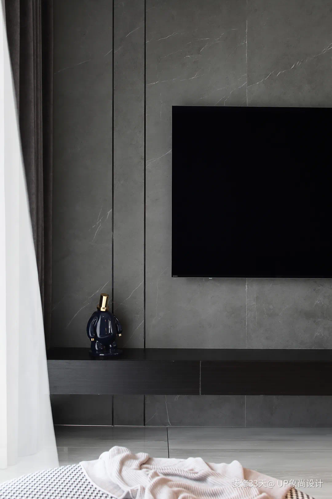 电视背景墙,灰色岩板做简单的线条分割,与悬空的电视柜交错布置