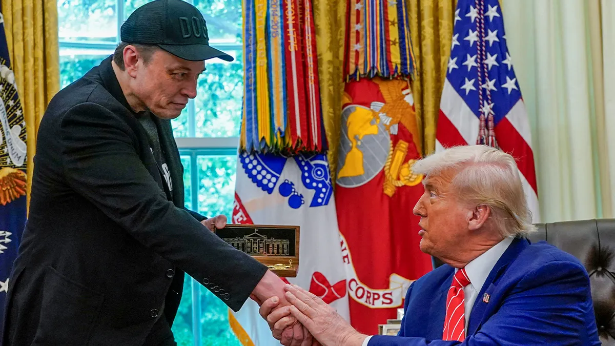 Elon Musk receives a golden key from President Donald Trump in the Oval Office at the White House in Washington, D.C., May 30, 2025.  (Reuters/Nathan Howard)