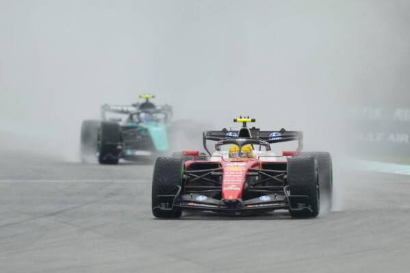 1 of 3 | Ferrari driver Lewis Hamilton of Britain steers his car during the formation lap prior to the delayed start of the Bahrain Grand Prix in Sepang, Malaysia, Sunday, Oct. 4, 2026. (AP Photo/Aijaz Rahi) License this photo