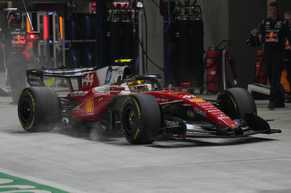 1 of 3 | Ferrari driver Lewis Hamilton of Britain arrives for a pit service during the Singapore Formula One Grand Prix race in Singapore, Sunday, Oct. 11, 2026. (AP Photo/Ng Han Guan, Pool) License this photo