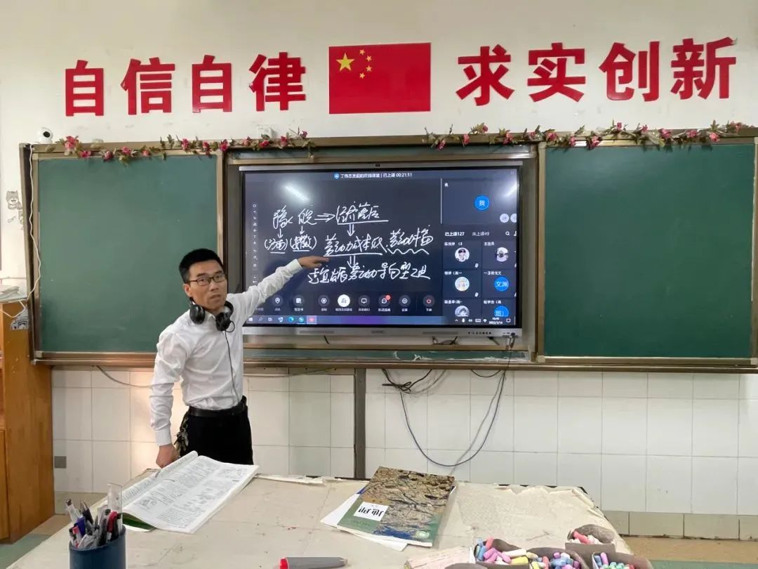 在望亭中学的一间教室里,副校长,地理老师丁伟忠正在进行线上教学.