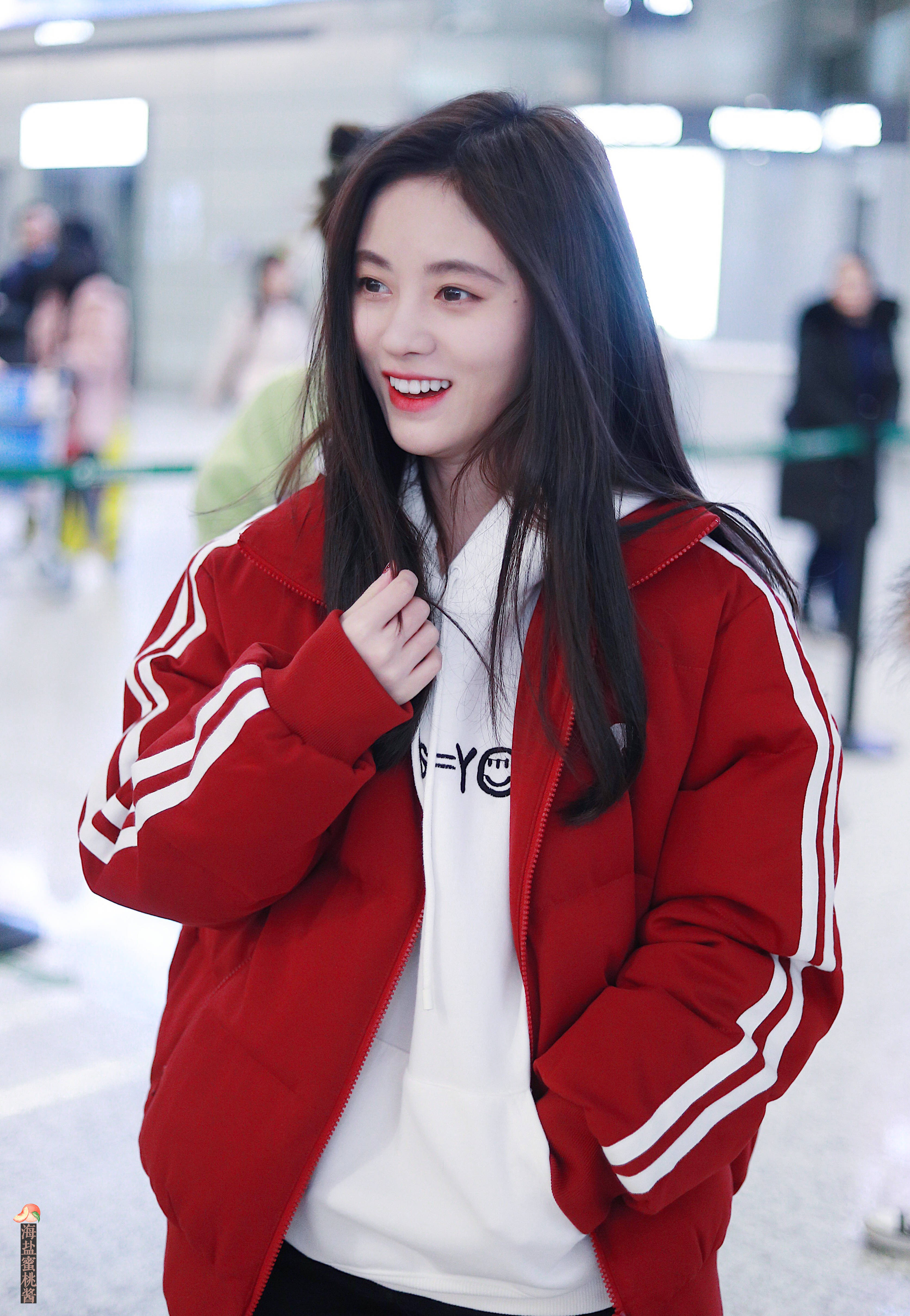 鞠婧祎穿红色羽绒服内搭白色卫衣现身机场,皮肤白皙,笑容甜美.