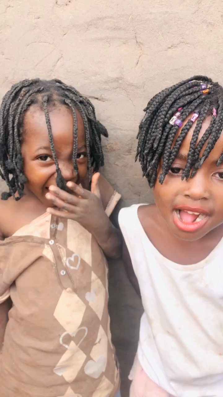 两个绑着脏辫的非洲小女孩,哈哈 一个可爱活泼,一个比较冷漠