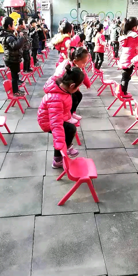 元旦会,幼儿园的小朋友们在跳凳子舞