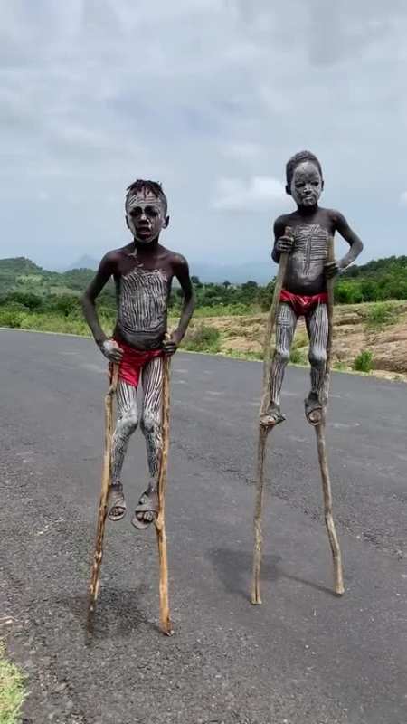 原始部落的斑马族,一群孩子踩高跷在马路上,看着很吓人!